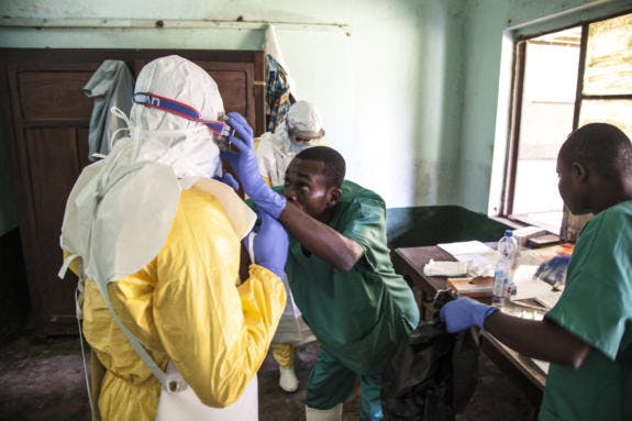 Ebola-health-workers-get-ready-to-attend-to-suspected-Ebola-patients-DRC-575x383.jpg