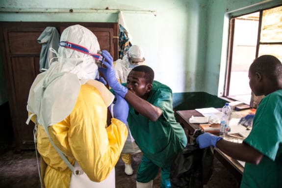 Ebola-health-workers-get-ready-to-attend-to-suspected-Ebola-patients-DRC-575x383.jpg